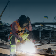 A welder works on a construction site of a highway in Ukraine